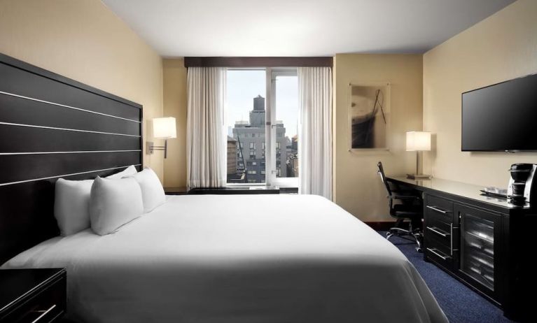 Delux king room with TV and work desk at Hilton New York Fashion District.