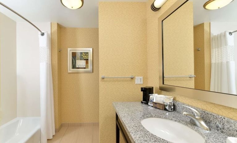 Private guest bathroom with combined shower and tub at Hampton Inn Iowa City/University Area.