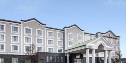 Exterior and parking area at Park Manor Hotel.