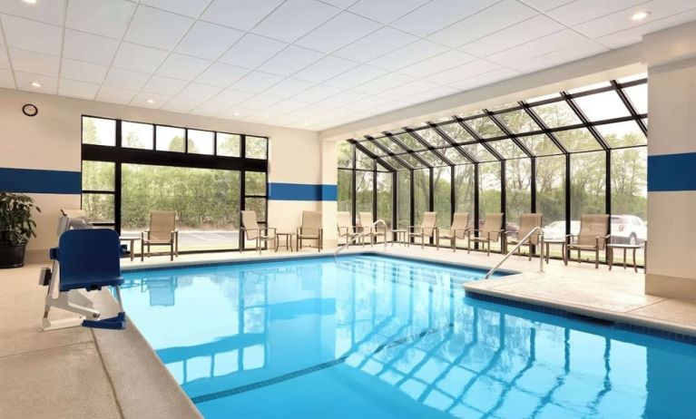 Indoor pool with lounge chairs at DoubleTree By Hilton Hartford - Bradley Airport.