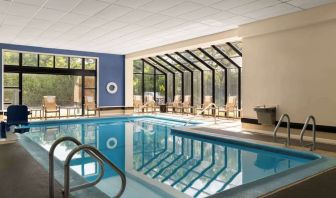 Indoor heated pool with lounge chairs at DoubleTree By Hilton Hartford - Bradley Airport.
