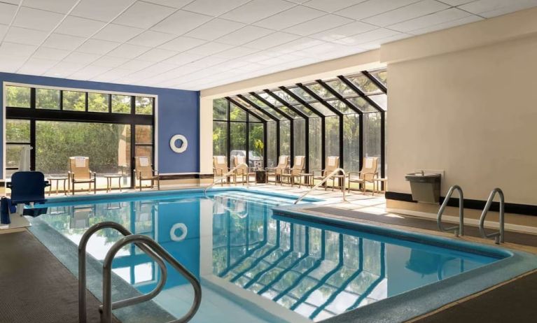 Indoor heated pool with lounge chairs at DoubleTree By Hilton Hartford - Bradley Airport.
