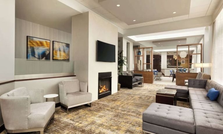 Lobby lounge area with fireplace at DoubleTree By Hilton Hartford - Bradley Airport.