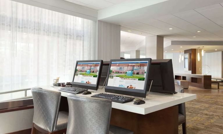 Business center with computers, printer and ergonomic chairs at DoubleTree By Hilton Hartford - Bradley Airport.