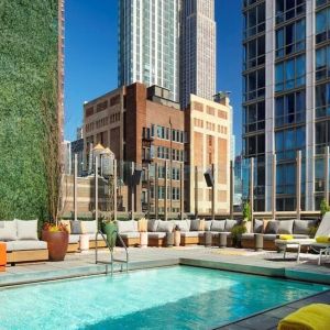 Stunning outdoor pool surrounded by skyscrapers at Royalton Park Avenue.