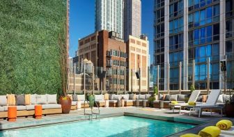 Stunning outdoor pool surrounded by skyscrapers at Royalton Park Avenue.