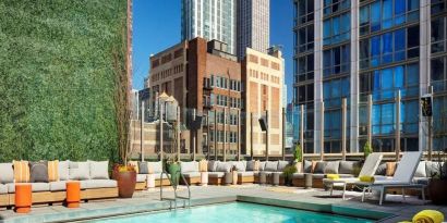 Stunning outdoor pool surrounded by skyscrapers at Royalton Park Avenue.