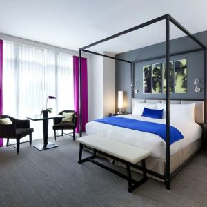 King bedroom with seating area and natural light at Royalton Park Avenue.
