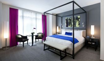King bedroom with seating area and natural light at Royalton Park Avenue.