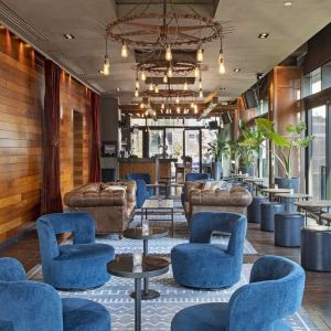 Lounge and coworking area beside elevators at Royalton Park Avenue.
