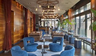 Lounge and coworking area beside elevators at Royalton Park Avenue.
