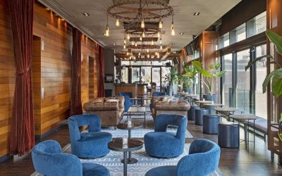 Lounge and coworking area beside elevators at Royalton Park Avenue.
