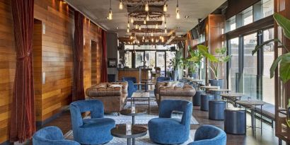 Lounge and coworking area beside elevators at Royalton Park Avenue.
