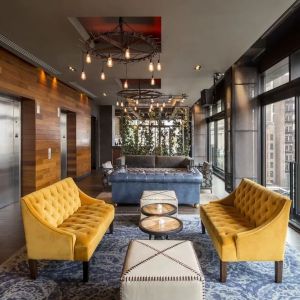 Lounge and coworking area beside elevators at Royalton Park Avenue.