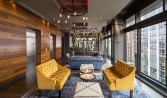 Lounge and coworking area beside elevators at Royalton Park Avenue.