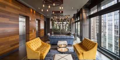 Lounge and coworking area beside elevators at Royalton Park Avenue.