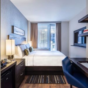 Day use room with work desk and balcony at The Bernic Hotel New York City, Tapestry Collection By Hilton.
