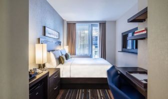 Day use room with work desk and balcony at The Bernic Hotel New York City, Tapestry Collection By Hilton.
