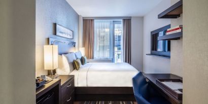 Day use room with work desk and balcony at The Bernic Hotel New York City, Tapestry Collection By Hilton.

