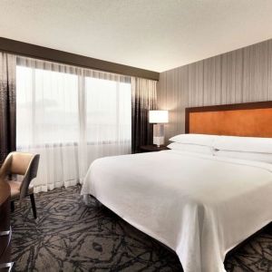 Delux king room with TV and work desk at Embassy Suites By Hilton Santa Clara Silicon Valley.