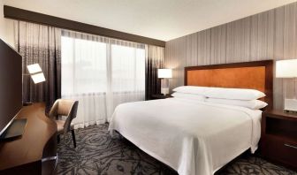 Delux king room with TV and work desk at Embassy Suites By Hilton Santa Clara Silicon Valley.