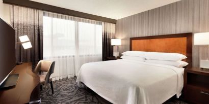 Delux king room with TV and work desk at Embassy Suites By Hilton Santa Clara Silicon Valley.