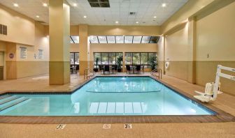 Relaxing indoor pool with seating area at Embassy Suites By Hilton Santa Clara Silicon Valley.