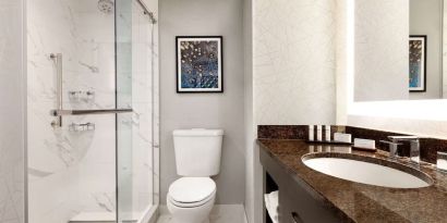 Private guest bathroom with shower at Embassy Suites By Hilton Santa Clara Silicon Valley.