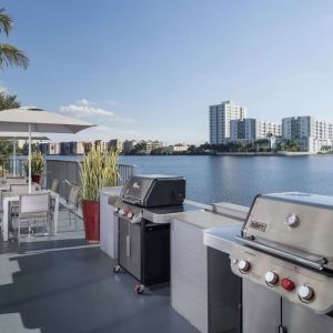 Grill and picnic area with a great view of the lagoon at Homewood Suites By Hilton Miami Airport-Blue Lagoon.