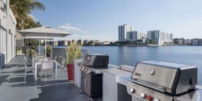Grill and picnic area with a great view of the lagoon at Homewood Suites By Hilton Miami Airport-Blue Lagoon.