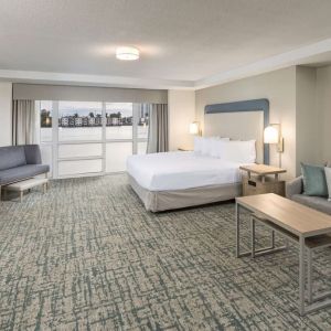 Spacious day use room with sofa and a view of the Blue Lagoon at Homewood Suites By Hilton Miami Airport-Blue Lagoon.