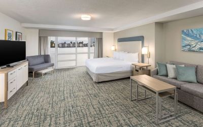 Spacious day use room with sofa and a view of the Blue Lagoon at Homewood Suites By Hilton Miami Airport-Blue Lagoon.