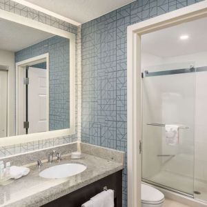 Guest bathroom with shower at Homewood Suites By Hilton Miami Airport-Blue Lagoon.