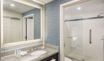 Guest bathroom with shower at Homewood Suites By Hilton Miami Airport-Blue Lagoon.