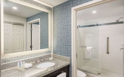 Guest bathroom with shower at Homewood Suites By Hilton Miami Airport-Blue Lagoon.