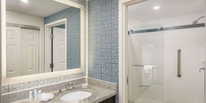Guest bathroom with shower at Homewood Suites By Hilton Miami Airport-Blue Lagoon.