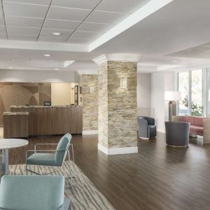 Lobby and coworking lounge at Homewood Suites By Hilton Miami Airport-Blue Lagoon.