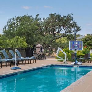 One of the 3 outdoor pools with loungers at Hilton San Antonio Hill Country.
