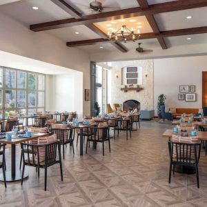 Dining area with natural light perfect for coworking at Hilton San Antonio Hill Country.