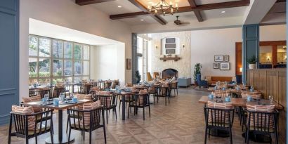 Dining area with natural light perfect for coworking at Hilton San Antonio Hill Country.