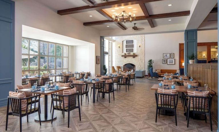 Dining area with natural light perfect for coworking at Hilton San Antonio Hill Country.