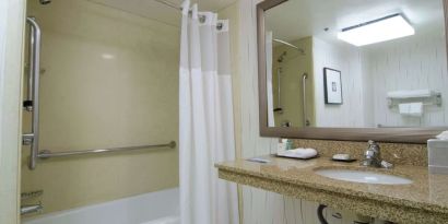 Guest bathroom with shower and tub at Hilton Los Angeles Airport.