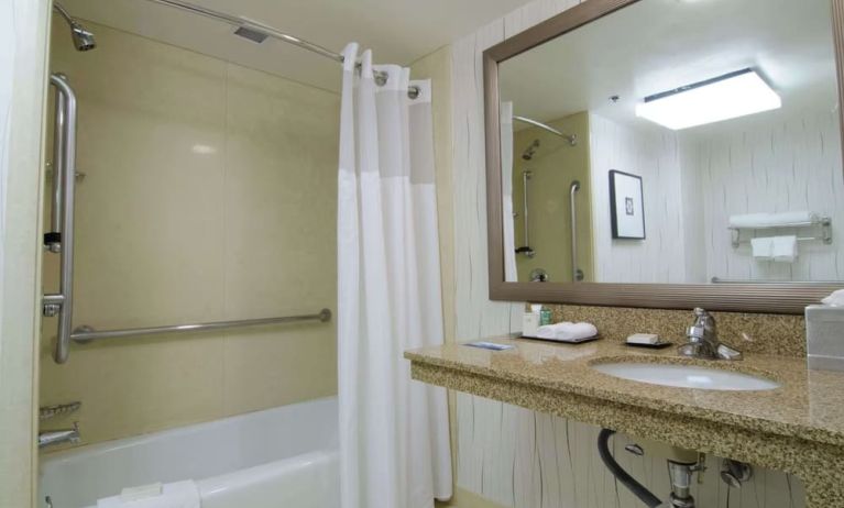 Guest bathroom with shower and tub at Hilton Los Angeles Airport.