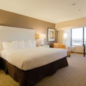 Delux king room with work desk and natural light at Hilton Los Angeles Airport.