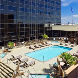 Stunning outdoor pool surrounded by loungers at Hilton Los Angeles Airport.