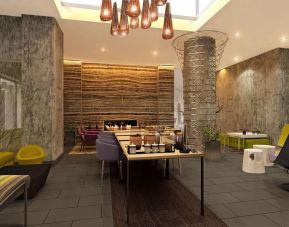Lobby lounge and workspace with coffee service and fireplace at Hilton Garden Inn New York/Manhattan-Midtown East.