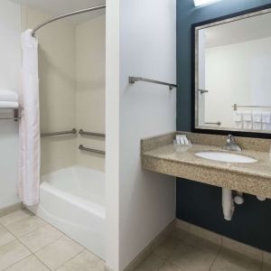 Private guest bathroom with combined shower and tub at Hilton Garden Inn Dothan.