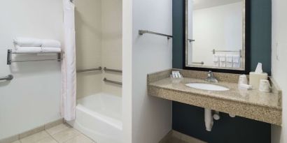 Private guest bathroom with combined shower and tub at Hilton Garden Inn Dothan.