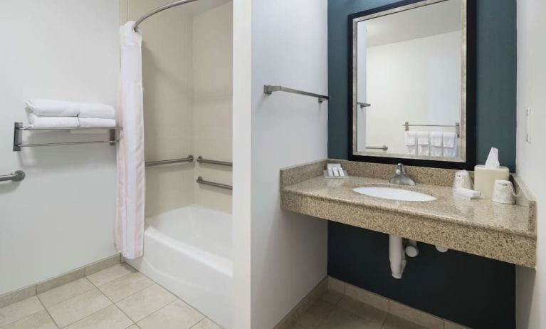 Private guest bathroom with combined shower and tub at Hilton Garden Inn Dothan.