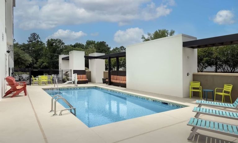 Stunning outdoor pool with seating area at Home2 Suites By Hilton Charleston Airport/Convention Center.
